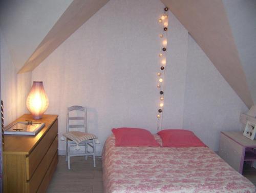 a bedroom with a bed and a desk and a chair at grande chambre lumineuse et spacieuse 22m2 in Guérande