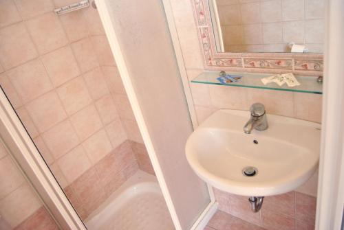 a bathroom with a sink and a shower at Hotel Beverly in Rimini