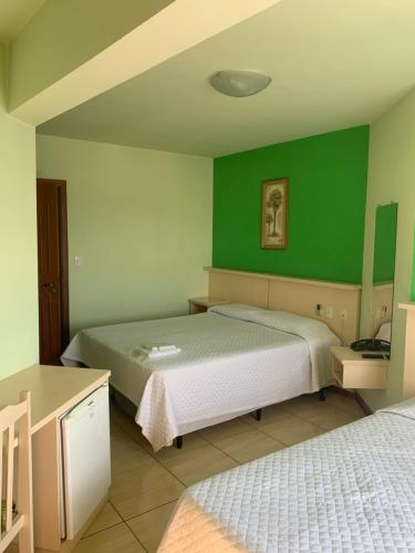Postel nebo postele na pokoji v ubytování Hoteis Cattoni Executive
