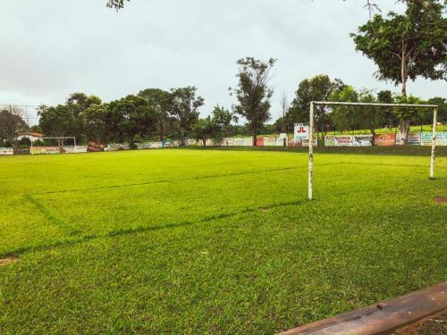 a soccer field with a goal in the grass at Chalés JL in Capitólio
