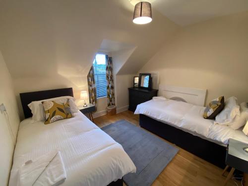 a bedroom with two beds and a television in it at No. 20 in Inverness