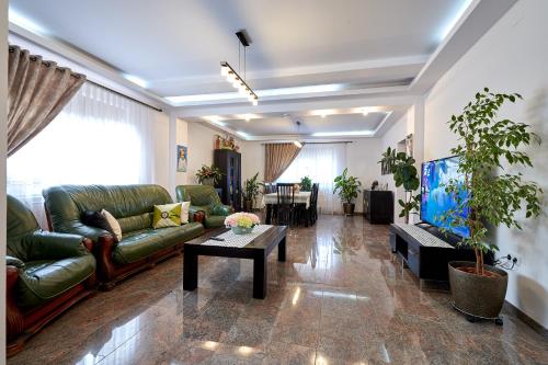 a living room with a couch and a table at Casa cu Flori Moisei in Moisei