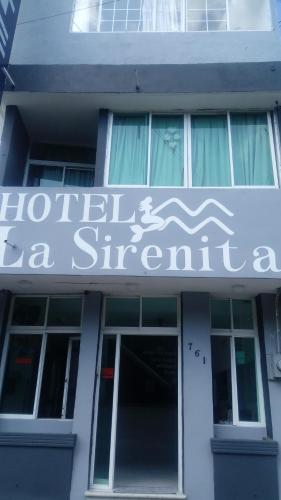 a building with a sign for a store at La Sirenita in Veracruz