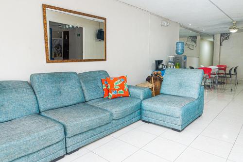 a blue couch and two chairs in a living room at Hotel Boston Superior in Barranquilla