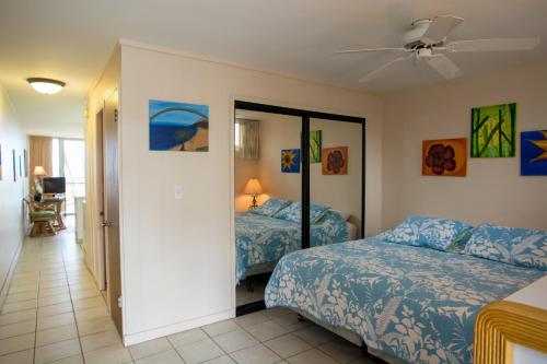 a bedroom with two beds and a ceiling fan at Hale Kai O'Kihei 120 in Kihei