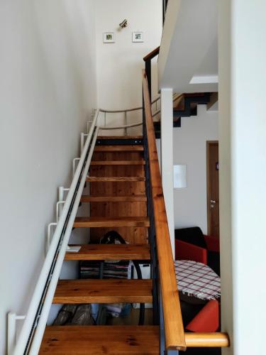 a staircase leading up to a room with a bed at Maria Rooms in Kuressaare