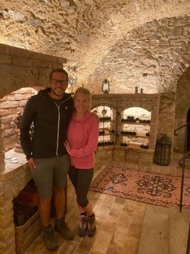 a man and a woman standing in a stone room at Pension Sunnseitn - Gasthof - Café - Weinkeller in Haslach an der Mühl