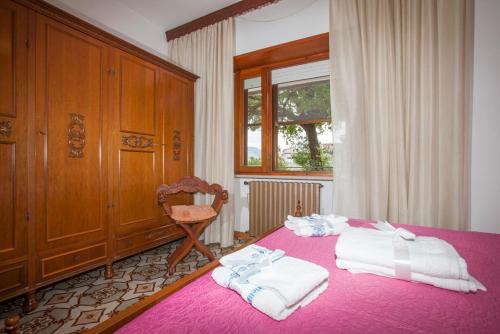 Ένα ή περισσότερα κρεβάτια σε δωμάτιο στο Villa Attilio