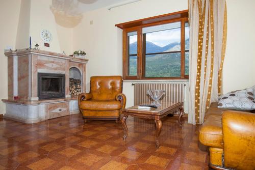 a living room with a couch and a chair at Villa Attilio in Balsorano Vecchio