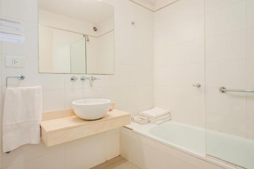 a white bathroom with a sink and a tub at WONDERFUL APARTMENT - PALERMO WIFI - in Buenos Aires