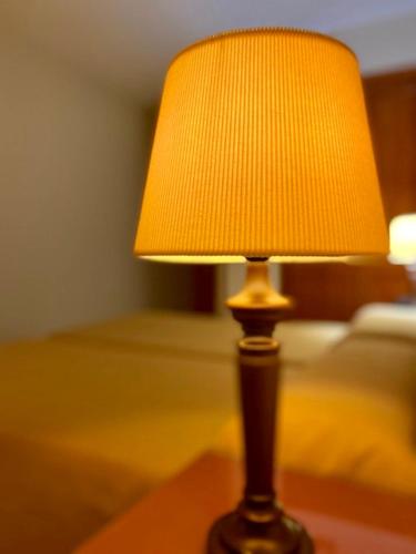 a lamp sitting on a table in a room at Hostal León in Trujillo