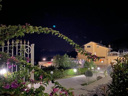 a lit up arch at night with a building at Villa Marchesa in Castelnuovo Cilento