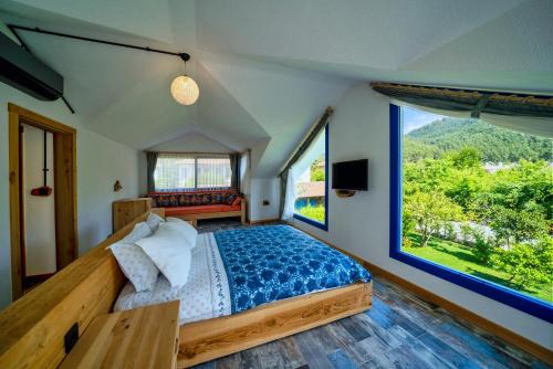 a bedroom with a bed and a large window at Only Blue Villa in Göcek