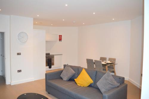 a living room with a couch and a table at St Albans - Luxury 1 Bedroom Apartment in Saint Albans