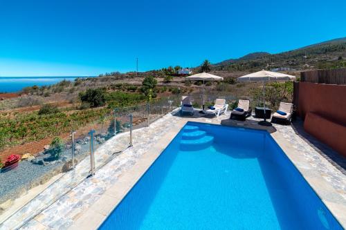 a swimming pool with a view of the ocean at Casa la Viña in Puntagorda