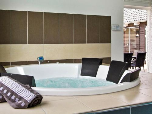 a jacuzzi tub with chairs in a room at Holiday home Kappeln XI in Kappeln