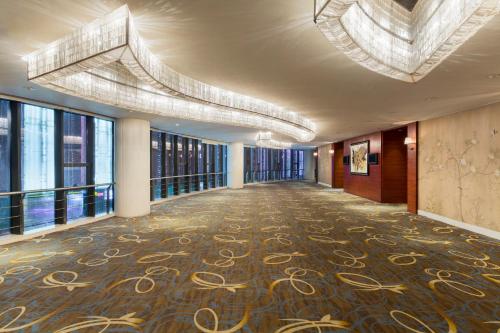 a hallway in a building with a large room with windows at Holiday Inn Nanjing Aqua City by IHG in Nanjing