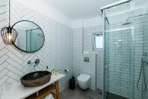 a bathroom with a sink and a glass shower at Blue Bay Lifestyle - ex Bali Blue Bay in Balíon