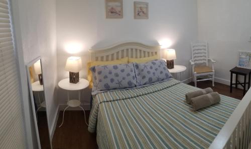 a bedroom with a bed with two tables and two lamps at La Villa Azul - A Beachy Stay in Miami in Miami