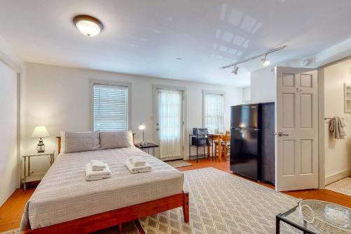a bedroom with a large bed and a refrigerator at Sheepscot Beauty in Wiscasset