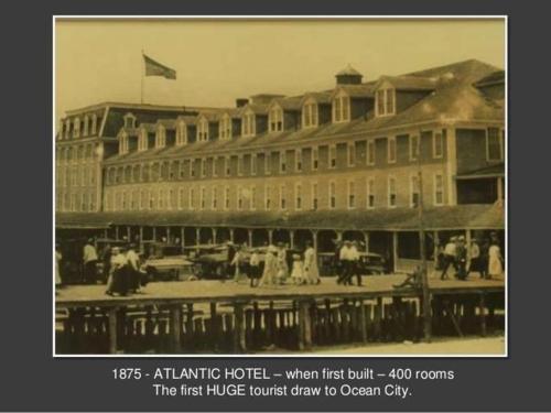 an old photo of a large building with people outside at Atlantic Hotel, Inc in Ocean City