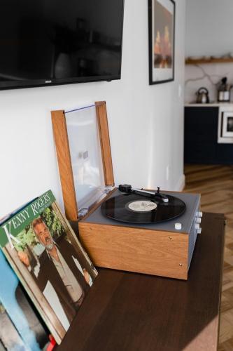 a record player sitting on top of a table with a vinyl record at Mint House Dallas - Downtown in Dallas