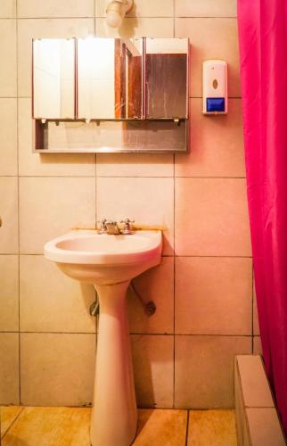 a bathroom with a sink and a mirror at Tierra Andina Hostel in Tilcara