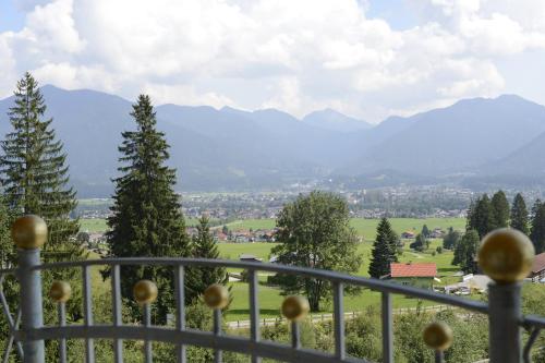 a balcony with a view of a town and mountains at Hotel Talhof Garni&more in Wängle bei Reutte in Reutte