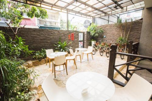 a patio with tables and chairs and bikes at Global Traveler Hotel in Kaohsiung