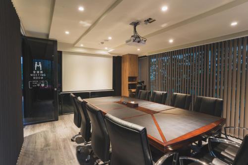 a conference room with a wooden table and chairs at Royal Rose Hotel Xinsheng in Taipei