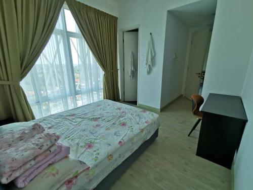 a bedroom with a bed and a large window at DELUXE HOMESTAY @ ONE RESIDENCE in Kota Bharu