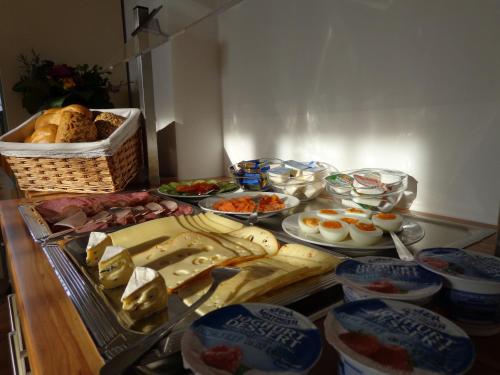 a table with many different types of food on it at Garni Hotel Zum Hothertor in Görlitz
