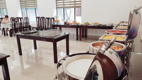 a restaurant with a buffet of food on display at MOMALI Hotel Ninh Binh in Ninh Binh