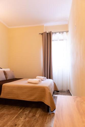 a bedroom with two beds and a window at Evdokia's Apartments and Rooms in Neos Marmaras