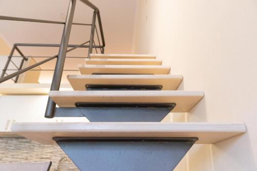 a set of stairs in a building with a railing at Evdokia's Apartments and Rooms in Neos Marmaras