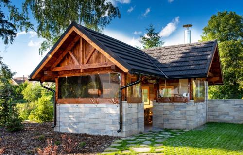 a small house with a gambrel roof at Apartmány Roháče in Zuberec