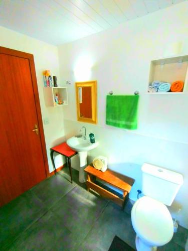 a bathroom with a toilet and a sink at Casablanca do Rosa in Praia do Rosa