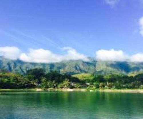 a large body of water with a mountain in the background at Laster Jony's in Tuk Tuk