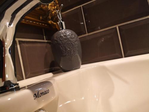 a bathroom sink with a toothbrush on a faucet at Затишні апартаменти, Дерибасівська in Odesa