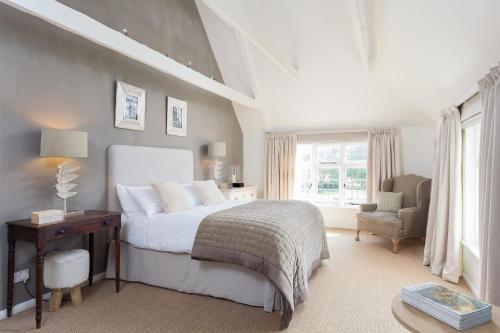 Schlafzimmer mit einem Bett, einem Schreibtisch und einem Stuhl in der Unterkunft Dormestone Farm by Bloom Stays in Ashford
