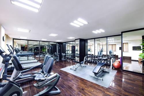 a gym with a lot of treadmills and exercise equipment at The Yangtze Boutique Shanghai in Shanghai