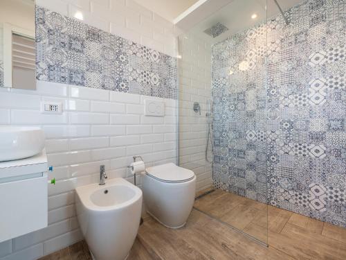 a bathroom with a toilet and a sink and a shower at Il Profumo del Mare GuestHouse in Cagliari