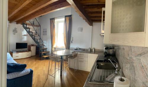 a kitchen with a table and a staircase in a room at Serendipity Quando l'Amore è Magia in Bergamo