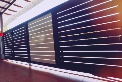 a wall of metal garage doors in a building at The Floral Home in Melaka