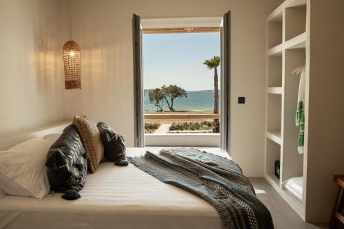 A bed or beds in a room at Seesoo Paros Beachfront Resort