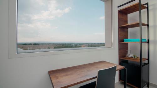 a window in a room with a wooden table and a chair at CIRERA SICILY in Marzamemi