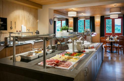 a large kitchen with a buffet of food at JUFA Hotel am Sigmundsberg in Mariazell