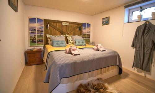 a bedroom with a bed with two stuffed animals on it at Romantic Klaksvik apartment in Klaksvík