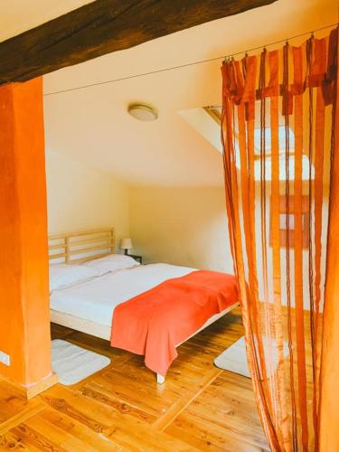 a bedroom with a bed and a curtain at Počitniška hiša Lazar in Kobarid