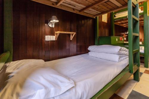 A bed or beds in a room at Hofang Guest House